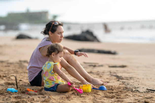 istock Ethnic Mother Playing With Toddler At Beach On Vacation 1432057890