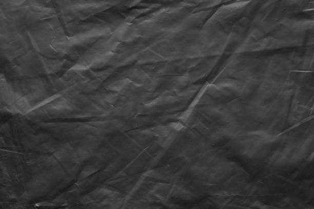istock transparent plastic bag wrap overlay texture on black background 1432058935