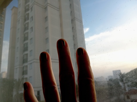 A hand on the white window