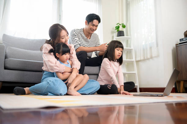 istock Asian family with children using laptop computer at home 1432062503