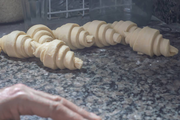 Baker making croissant before going to the oven,bakery concept with coppy space.