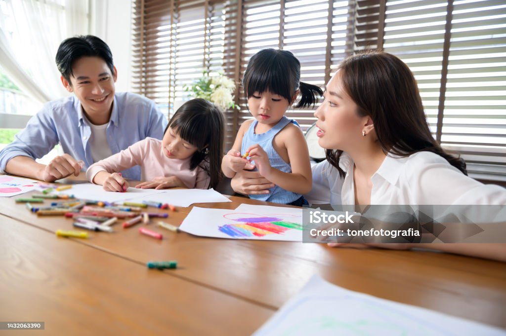 Asian family with children Drawing and painting on table in playing room at home, Educational game. Preschool Student Stock Photo