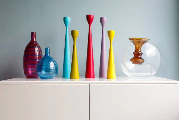 Colorful mid century modern decor including vases and candlesticks on display