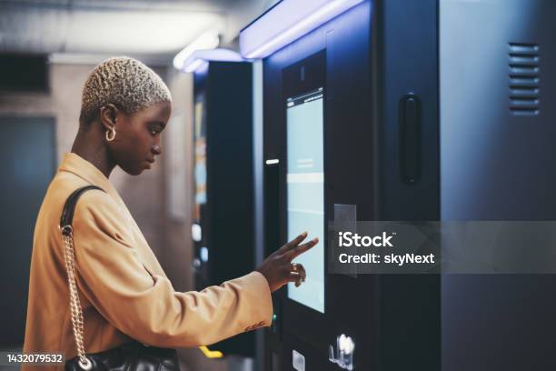 African Girl Using Ticket Terminal Stock Photo - Download Image Now - ATM, Touch Screen, Bank Teller