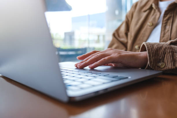 istock Closeup image of a woman working and touching on laptop computer touchpad 1432084413