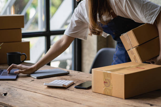 istock Operators work on receiving boxes and check online orders to prepare the packaging. Sell ​​to customers. SME business concept online e-commerce 1432084993