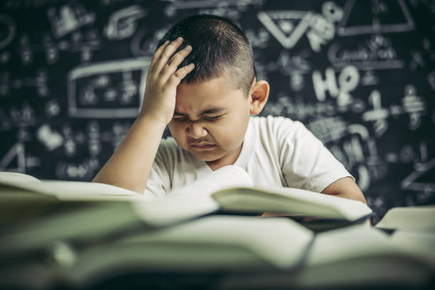 istock Boys with glasses write books and think in the classroom 1432087342