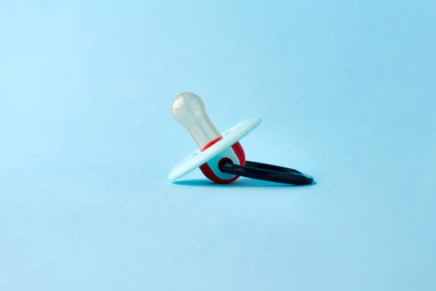 istock Baby pacifier on a blue background, close-up 1432088657