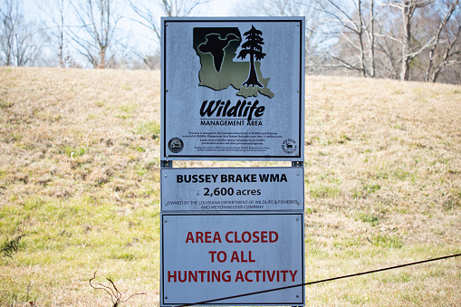Bussey Brake Wildlife Management Aarea Louisiana/USA  February 28 2022: Sign at the Bussey Brake WMA, noting that the land is owned by the Louisiana Department of Wildlife and Fisheries and The Weyerhaeuser, Company and is 2600 acres and closed to all hunting activity