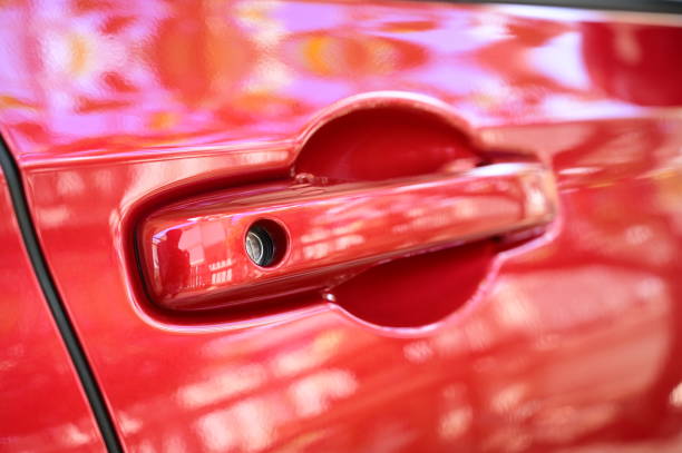 istock door handle of red car, transpotation industry 1432092212