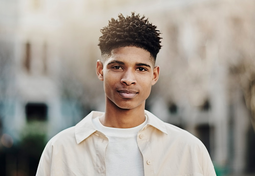Black man, university student and gen z portrait outdoor campus, college and school building in London. Headshot of young black guy, cool urban youth and knowledge in studying, learning and education