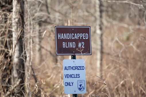 Bayou Cocodrie National Wildlife Refuge Louisiana/USA  February 4 2022: Sign for Handicapped Blind #2 at the Bayou Cocodrie National Wildlife Refuge above a second sign saying only authorized vehicles are allowed past it