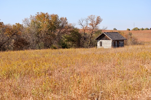 Old building on a prairie rolling hill in early autumn