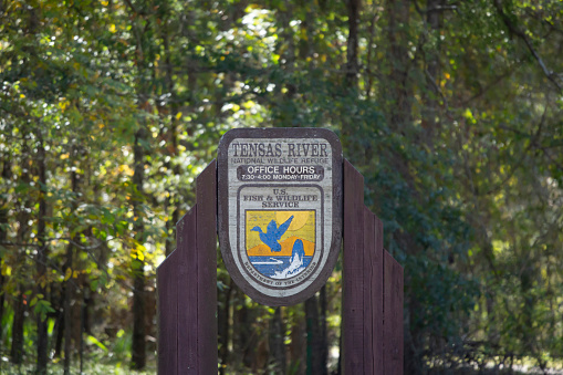 Tensas River National Wildlife Refuge, Louisiana/USA November 08 2019: Sign noting the office hours of the Tensas River National Wildlife Refuge and that the refuge is part of the U.S. Fish and Wildlife Service.