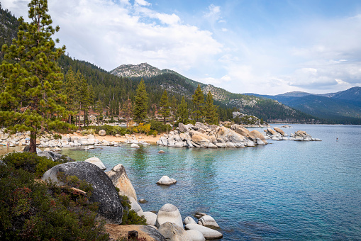Tranquil Lake Tahoe with glacial rocks and boulders with mountain views in Sand Harbor in Nevada