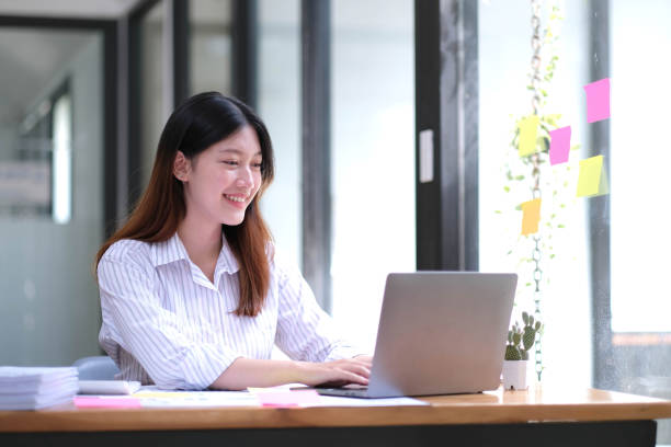 istock Asian Businesswoman Using laptop computer and working at office with calculator document on desk, doing planning analyzing the financial report, business plan investment, finance analysis concept. 1432109644
