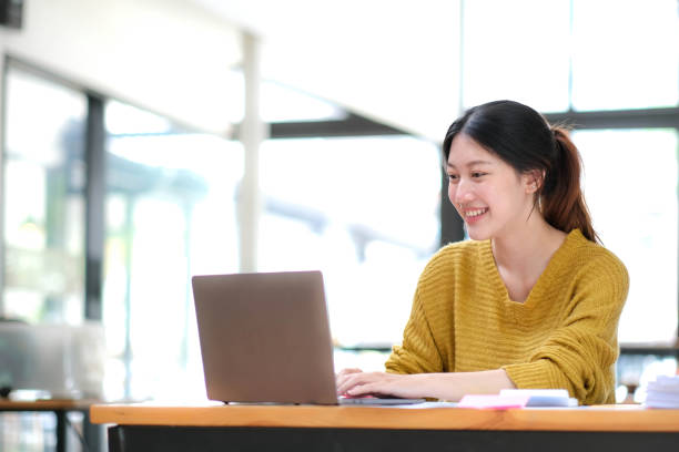 istock Asian Businesswoman Using laptop computer and working at office with calculator document on desk, doing planning analyzing the financial report, business plan investment, finance analysis concept. 1432109724