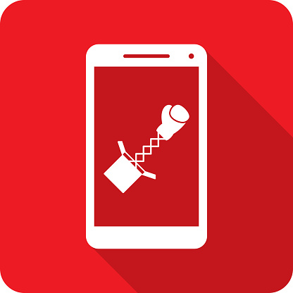 Vector illustration of a smartphone with boxing glove extending out of a box icon against a red background in flat style.