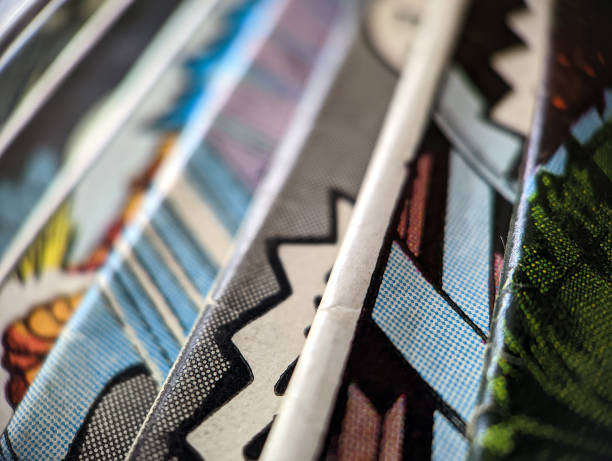 Closeup view of an old comic book collection creates colorful background paper texture with abstract shapes stock photo