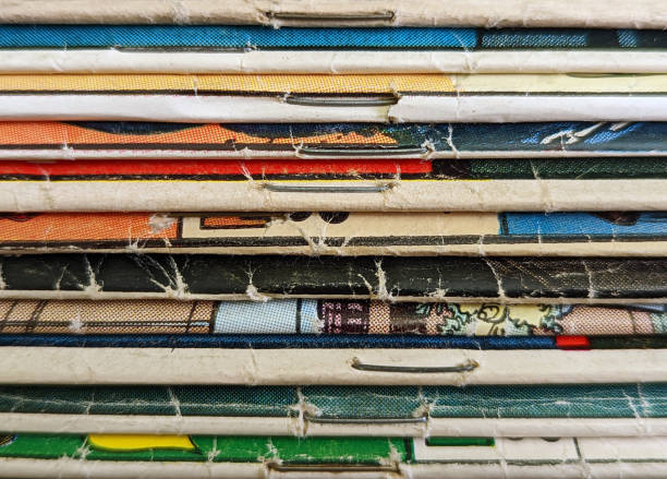 Stack of old vintage comic books creates colorful background texture with abstract shapes and colors stock photo