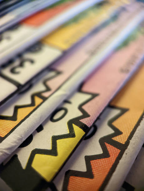 Closeup view of an old comic book collection stacked in a pile creates colorful background paper texture with abstract shapes stock photo