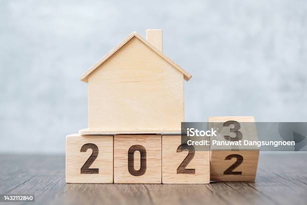 Flip 2022 To 2023 Block With House Model Real Estate Home Loan Tax Investment Financial Savings And New Year Resolution Concepts Stock Photo - Download Image Now