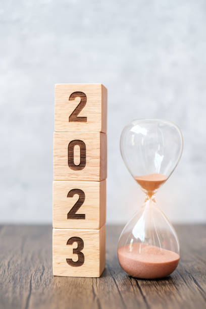 istock 2023 block with hourglass on table. Resolution, time, plan, goal, motivation, reboot, countdown  and New Year holiday concepts 1432112861