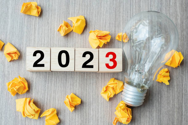 istock 2023 text wood cube blocks and crumbled paper with lightbulb on wooden table background. New Year New Ideas, Creative, Innovation, Imagination, inspiration, Resolution, Strategy and goal concept 1432113110
