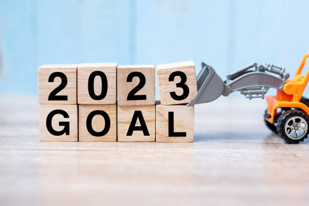 istock 2023 goal cube blocks with miniature truck or construction vehicle. New Start, Vision, Resolution, goal, industrial, Warehouse and happy New Year concept 1432113140