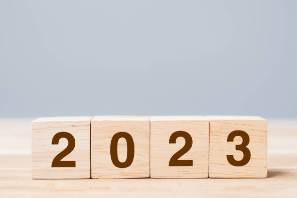 istock wooden cube block with 2023 text on table background. Resolution, plan, review, goal, start and New Year holiday concepts 1432113186