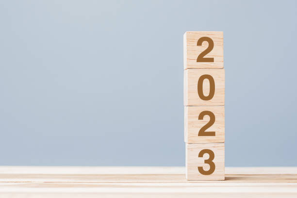 istock wooden cube block with 2023 text on table background. Resolution, plan, review, goal, start and New Year holiday concepts 1432113332