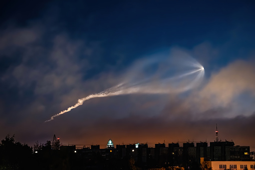 Soyuz space rocket launch. Space jellyfish in sky. Plume of rocket gases in sun at dawn. Jet trail from space rocket. Astronomical phenomenon over city.