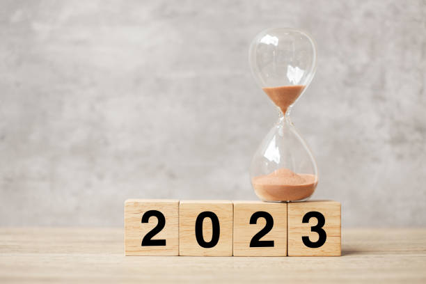 istock 2023 text with hourglass on table. Resolution, time, plan, goal, motivation, reboot, countdown  and New Year holiday concepts 1432113460