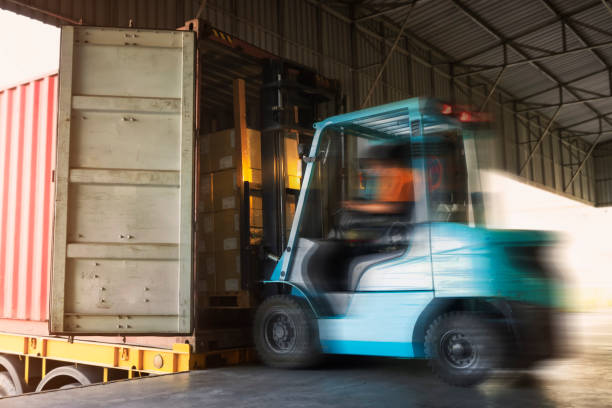 istock Forklift Tractor Loading Cargo Boxes Pallets into Container Trucks. Shipping Truck. Supply Chain Cargo Shipment. Distribution Supplies Warehouse. Freight Truck Transport Logistics. 1432113474