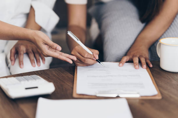 istock Real Estate Agent explain insurance and agreement contract to client before sign contract 1432114273