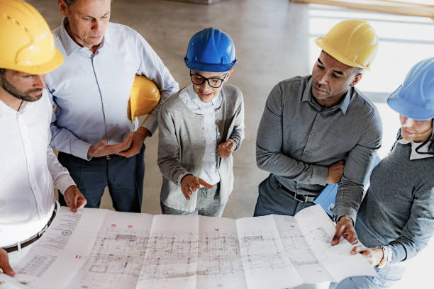 istock Team of architects analyzing blueprints in the office. 1432117256
