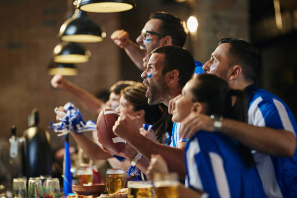 istock Cheering for favorite rugby team on TV in a bar! 1432118426