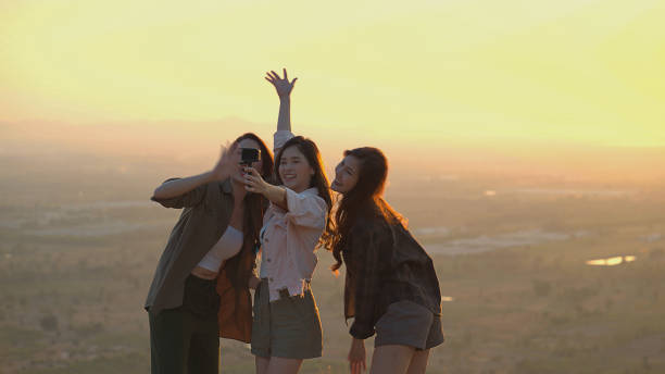 Group of Asian young women having fun and enjoying a summer vacation vlogging during sunset, Lifestyle, Blogger Travel.