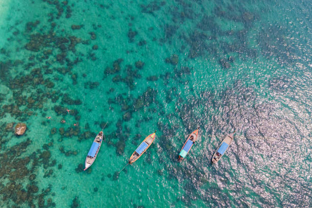 Aerial view of a longtail boat floatingin the blue sea, Andaman Sea, Thailand stock photo