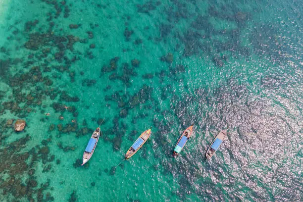 Aerial view of a longtail boat floatingin the blue sea, Andaman Sea, Thailand