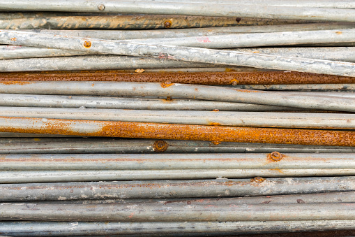 A pile of steel pipes on a construction site