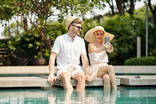 istock Couple taking selfie portrait at pool 1432122503