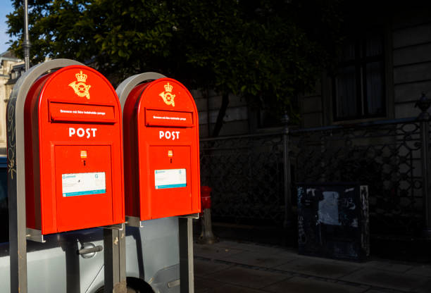 Copenhagen, Denmark - November 03, 2016: A traditional red public letterbox hanging on a wall