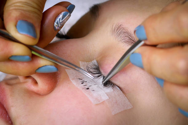 istock Eyelash extension procedure, woman eye with Long eyelashes 1432128117