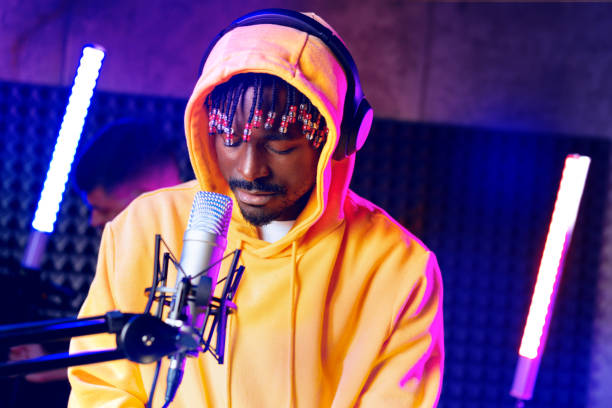 istock Young African performer recording his new track in recording studio 1432132009