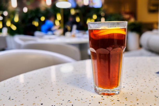 glass of lemon black tea on table