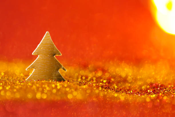 istock Christmas tree mini in gold glitter on a on a red background 1432136683
