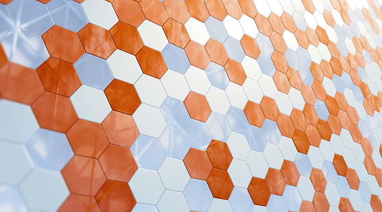 Abstract architectural surface with a modern hexagon pattern made of reflecting glass and metal elements. Copper and silver colored. Diminishing perspective.