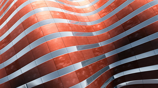 Abstract architecture with waving surface made of metal stripes and glass reflecting the bright sky light. Copper and silver colors with high key illumination.