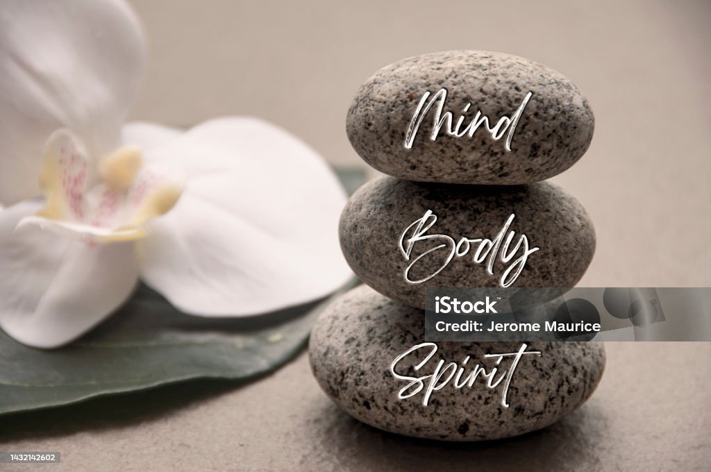 Mind, Body and Soul words engraved on zen stones with space for text. Health life concept. Mind, Body and Soul words engraved on zen stones with space for text. Massaging Stock Photo